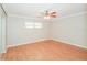 Bright bedroom featuring hardwood floors, ceiling fan, window, and neutral color paint at 1001 Meadowcrest Dr, Valrico, FL 33594