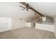 Upstairs room with carpeted floors, wood beams, and view of the downstairs living space at 1001 Meadowcrest Dr, Valrico, FL 33594