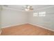 Bedroom with hardwood floors, closet, and window with mini blinds for natural light at 1001 Meadowcrest Dr, Valrico, FL 33594