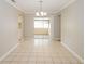 Dining area featuring tile floors, modern lighting, and sliding door access to the outdoors at 1001 Meadowcrest Dr, Valrico, FL 33594