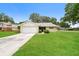 Charming single-story home with a well-maintained lawn and attached two-car garage at 1001 Meadowcrest Dr, Valrico, FL 33594