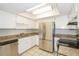 Efficient kitchen featuring stainless steel appliances, granite countertops, and ample cabinet space at 1001 Meadowcrest Dr, Valrico, FL 33594