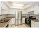 Bright kitchen featuring stainless steel appliances, granite countertops, and plentiful storage at 1001 Meadowcrest Dr, Valrico, FL 33594