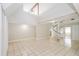 Spacious living room with high ceilings, tile floors, and a unique spiral staircase at 1001 Meadowcrest Dr, Valrico, FL 33594