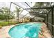 Enclosed pool featuring a diving board, ladder, and patio area for entertaining guests at 1001 Meadowcrest Dr, Valrico, FL 33594