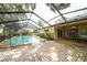 Enclosed pool featuring a fenced in area and patio with sliding glass door to enter the house at 1001 Meadowcrest Dr, Valrico, FL 33594