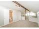Upstairs hallway with carpet, wood beams, and a view of the downstairs living space at 1001 Meadowcrest Dr, Valrico, FL 33594