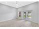 Bright, carpeted bedroom with backyard access through glass doors and great natural light at 4413 W Wallcraft Ave, Tampa, FL 33611