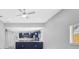 Open living space with kitchen area featuring blue cabinets, stainless appliances, and white countertops at 4413 W Wallcraft Ave, Tampa, FL 33611
