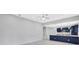 Open living space with modern lighting and access to the stylish, navy blue kitchen area at 4413 W Wallcraft Ave, Tampa, FL 33611