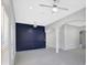Open-concept living room featuring a blue accent wall, ceiling fans and neutral walls at 4413 W Wallcraft Ave, Tampa, FL 33611