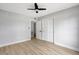 Bright bedroom featuring a ceiling fan and wood floors, offering a comfortable space at 8701 Thornwood Ln, Tampa, FL 33615
