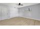 Comfortable bedroom featuring a ceiling fan, wood floors, and a spacious closet, offering ample storage at 8701 Thornwood Ln, Tampa, FL 33615