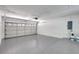 Spacious garage with epoxy floor, white walls, and overhead garage door at 8701 Thornwood Ln, Tampa, FL 33615