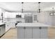 Updated kitchen with a center island, stainless steel appliances, white cabinets, and modern fixtures throughout at 8701 Thornwood Ln, Tampa, FL 33615