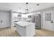 Updated kitchen with white cabinets, stainless steel appliances, a large island, and modern pendant lighting at 8701 Thornwood Ln, Tampa, FL 33615