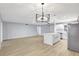 Bright and airy living area with modern flooring, recessed lighting, and an open layout to the kitchen area at 8701 Thornwood Ln, Tampa, FL 33615