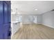 Open-concept living space with new flooring and stylish light fixtures, bathed in natural light from the front door at 8701 Thornwood Ln, Tampa, FL 33615