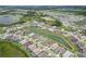 An aerial view of a sprawling community features multiple homes and serene lakes surrounded by greenery at 9201 Sanders Tree Loop, Wesley Chapel, FL 33545