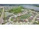 An aerial photograph shows houses in a developed area surrounding multiple water features and green spaces at 9201 Sanders Tree Loop, Wesley Chapel, FL 33545