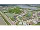 A beautiful aerial view shows homes surrounding several bodies of water and green space in a neighborhood at 9201 Sanders Tree Loop, Wesley Chapel, FL 33545