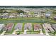 An aerial view of a beautiful planned community surrounding a tranquil lake and lush green spaces at 9201 Sanders Tree Loop, Wesley Chapel, FL 33545