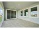 Spacious balcony featuring tile floors, windows and sliding glass doors with a community view at 9201 Sanders Tree Loop, Wesley Chapel, FL 33545