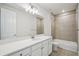Bright bathroom with a modern vanity, large mirror, and tiled shower-tub combination, perfect for relaxation at 9201 Sanders Tree Loop, Wesley Chapel, FL 33545