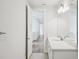 Bright bathroom featuring white vanity with stone countertop, large mirror, and modern lighting at 9201 Sanders Tree Loop, Wesley Chapel, FL 33545
