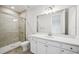 Modern bathroom featuring a glass enclosed shower, white vanity, and neutral finishes at 9201 Sanders Tree Loop, Wesley Chapel, FL 33545