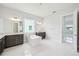 Spacious bathroom features a soaking tub, double vanities, and expansive mirrors in a bright and modern design at 9201 Sanders Tree Loop, Wesley Chapel, FL 33545