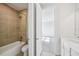 Bathroom featuring a shower and tub with decorative tiling, and an adjoining room at 9201 Sanders Tree Loop, Wesley Chapel, FL 33545