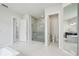 Elegant bathroom featuring glass-enclosed shower, soaking tub, dual vanity, and bright, modern fixtures at 9201 Sanders Tree Loop, Wesley Chapel, FL 33545