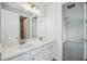 Bathroom featuring double sinks, vanity with white cabinets, and a large mirror at 9201 Sanders Tree Loop, Wesley Chapel, FL 33545
