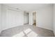 Spacious bedroom featuring neutral carpet, walk-in closet, and an adjoining bathroom at 9201 Sanders Tree Loop, Wesley Chapel, FL 33545