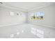 Bright and airy bedroom with tray ceilings, large windows and glossy marble floors at 9201 Sanders Tree Loop, Wesley Chapel, FL 33545