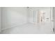 A bright bedroom featuring a white door and marble flooring at 9201 Sanders Tree Loop, Wesley Chapel, FL 33545