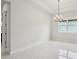 Open dining room bathed in natural light featuring a modern chandelier and neutral decor at 9201 Sanders Tree Loop, Wesley Chapel, FL 33545