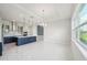 Open-concept dining area with a modern kitchen and a large window at 9201 Sanders Tree Loop, Wesley Chapel, FL 33545