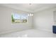Well-lit dining room features a modern chandelier and picturesque water view at 9201 Sanders Tree Loop, Wesley Chapel, FL 33545
