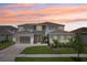 Beautiful two-story home showcasing a modern elevation, well-manicured lawn, and two-car garage at 9201 Sanders Tree Loop, Wesley Chapel, FL 33545