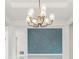 Close up of modern light fixture and accent wall in the bright foyer at 9201 Sanders Tree Loop, Wesley Chapel, FL 33545