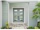 Close-up of a modern double door entrance with glass panels and stylish hardware at 9201 Sanders Tree Loop, Wesley Chapel, FL 33545