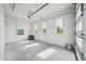 Spacious garage with three windows and concrete flooring at 9201 Sanders Tree Loop, Wesley Chapel, FL 33545