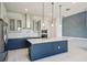Modern kitchen boasts stainless steel appliances, center island, and stylish pendant lighting at 9201 Sanders Tree Loop, Wesley Chapel, FL 33545
