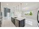 Bright, open kitchen features a large island with pendant lighting and stainless steel appliances at 9201 Sanders Tree Loop, Wesley Chapel, FL 33545