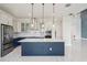 Gourmet kitchen features a center island, stainless steel appliances, and modern pendant lights at 9201 Sanders Tree Loop, Wesley Chapel, FL 33545