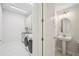 Well-equipped laundry room adjacent to a half bath at 9201 Sanders Tree Loop, Wesley Chapel, FL 33545