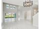 Bright, open-concept living room features soaring ceilings and glossy marble flooring at 9201 Sanders Tree Loop, Wesley Chapel, FL 33545