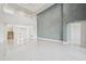 Open concept living area with high ceilings and eye-catching decorative wall at 9201 Sanders Tree Loop, Wesley Chapel, FL 33545